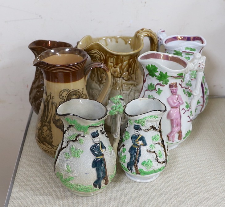 A Doulton Lambeth South Africa 1900 commemorative jug, 21cm, two relief moulded Volunteer jugs and four other jugs